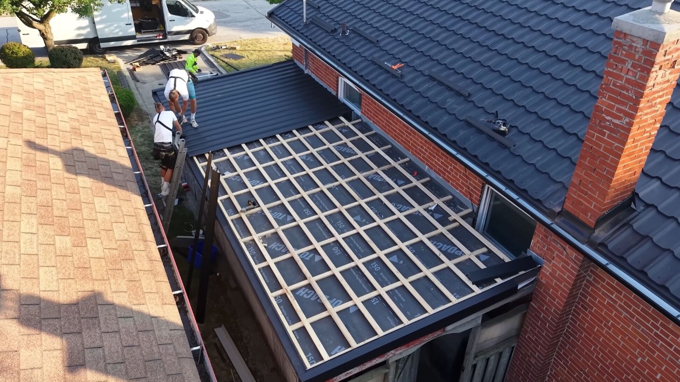 Professional roofing crew working on brick house in La Puente, CA
